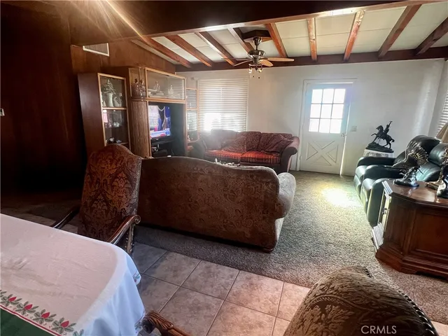 a reading room with wooden floor and furniture