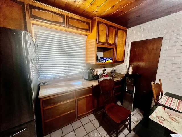 a bed sitting in a bedroom next to a wooden closet