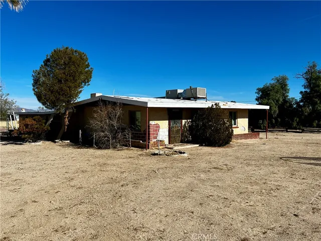 a view of a swimming pool with a lawn chairs and a fire pit
