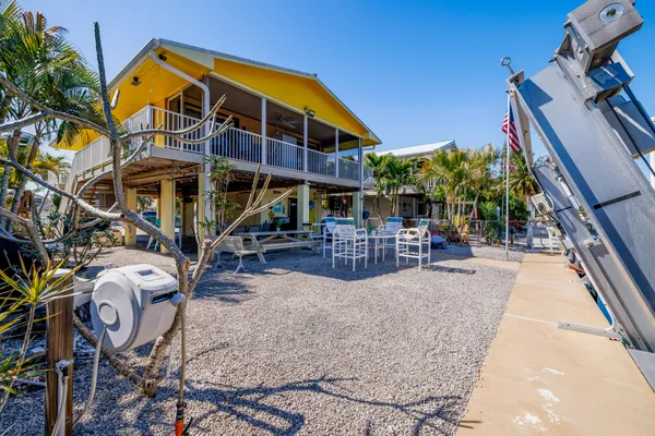 a view of a house with backyard and sitting area