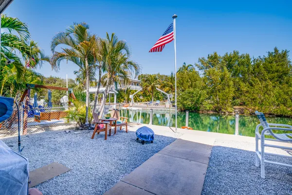 a view of a swimming pool with lounge chairs in patio
