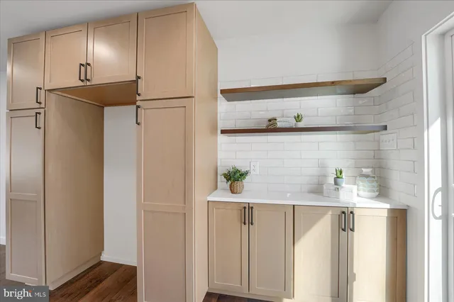a kitchen with stainless steel appliances a refrigerator and cabinets