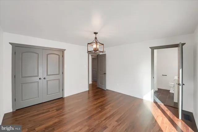 a view of a livingroom with wooden floor and a cabinet