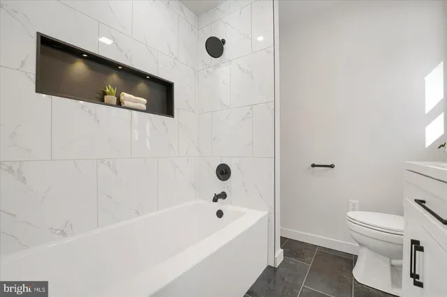 a bathroom with a bathtub and a toilet