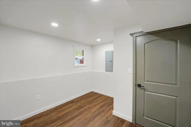 a view of an empty room with wooden floor