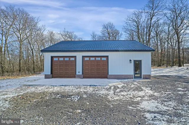 a view of a house with a snow in the yard