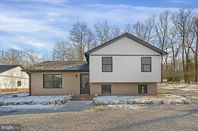 a view of a house with snow on the road