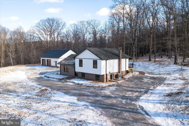 a view of a house with a yard covered in snow