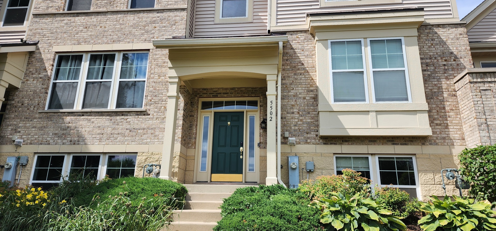 front view of a brick house with a large windows