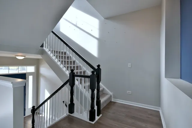 a view of an entryway with wooden floor