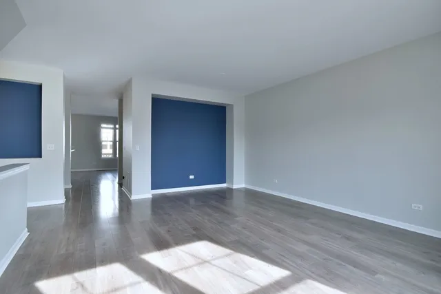 a view of an empty room and wooden floor