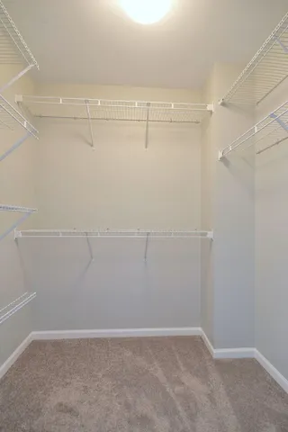 a spacious bathroom with a double vanity sink toilet and a mirror