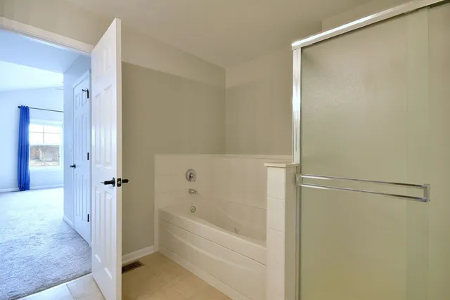 a bedroom with a bed and a potted plant