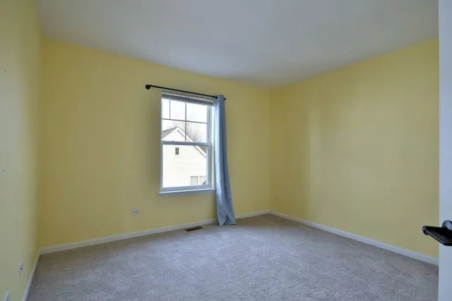 a livingroom with workspace and a window