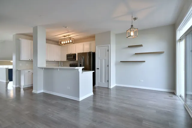 a view of a kitchen with furniture and wooden floor