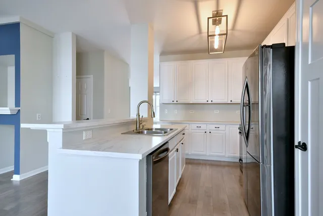 a kitchen with a sink stove and refrigerator
