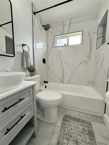 a bathroom with a sink a toilet and a bathtub