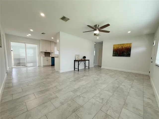 a view of a livingroom with furniture and a ceiling fan