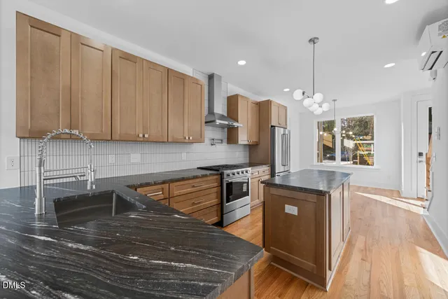 a kitchen with granite countertop a sink and cabinets