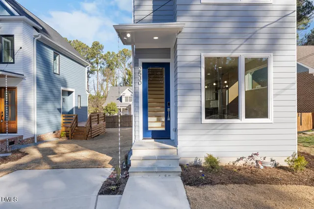 a view of front door with wooden floor and stairs