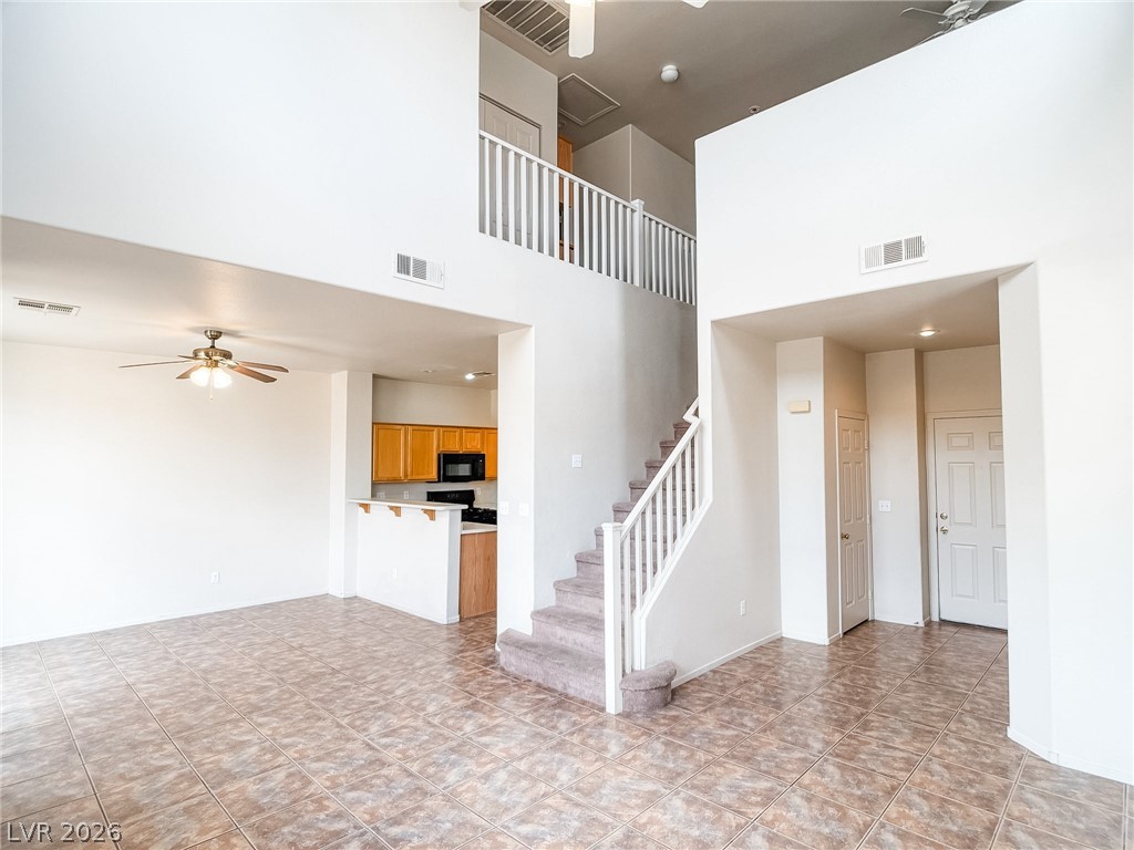 228 Positive Point Street Henderson, NV 89012 - Photo 2 of 27 The soaring vaulted ceiling and tiled flooring create an open and airy living space, complemented by a convenient kitchen pass-through.