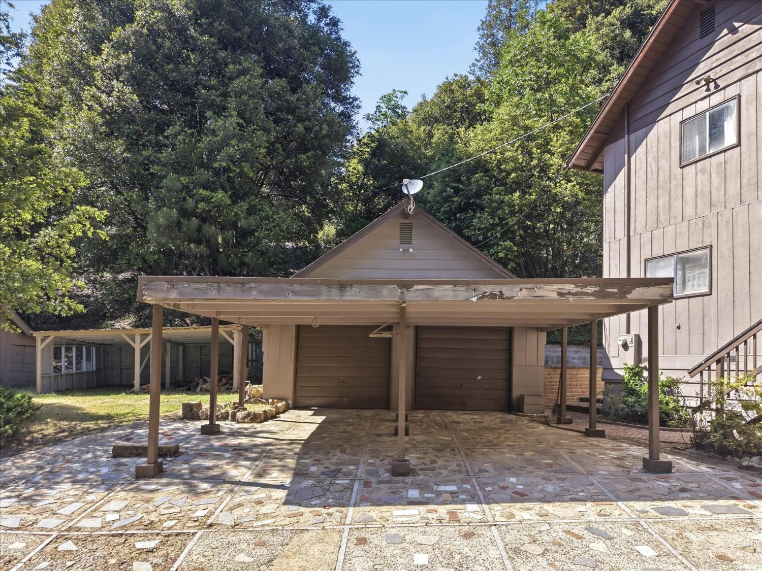 45167 Tolladay Road Oakhurst, CA 93644 - Photo 30 of 50 a front view of a house with a garden and porch