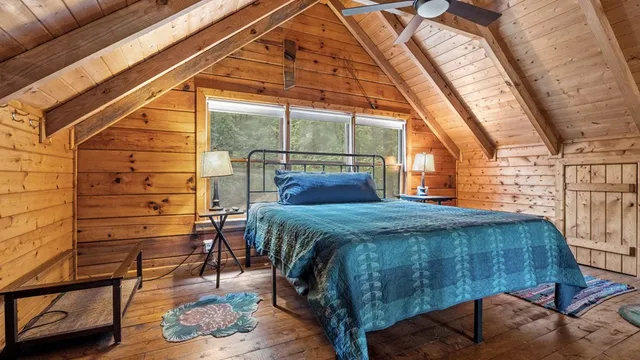 a bedroom with a bed and a window