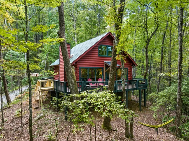 a view of a chair and table in backyard of the house