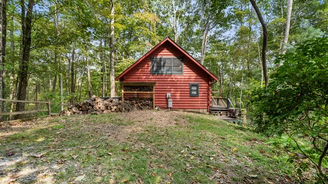 a view of a backyard with barn and wooden fence