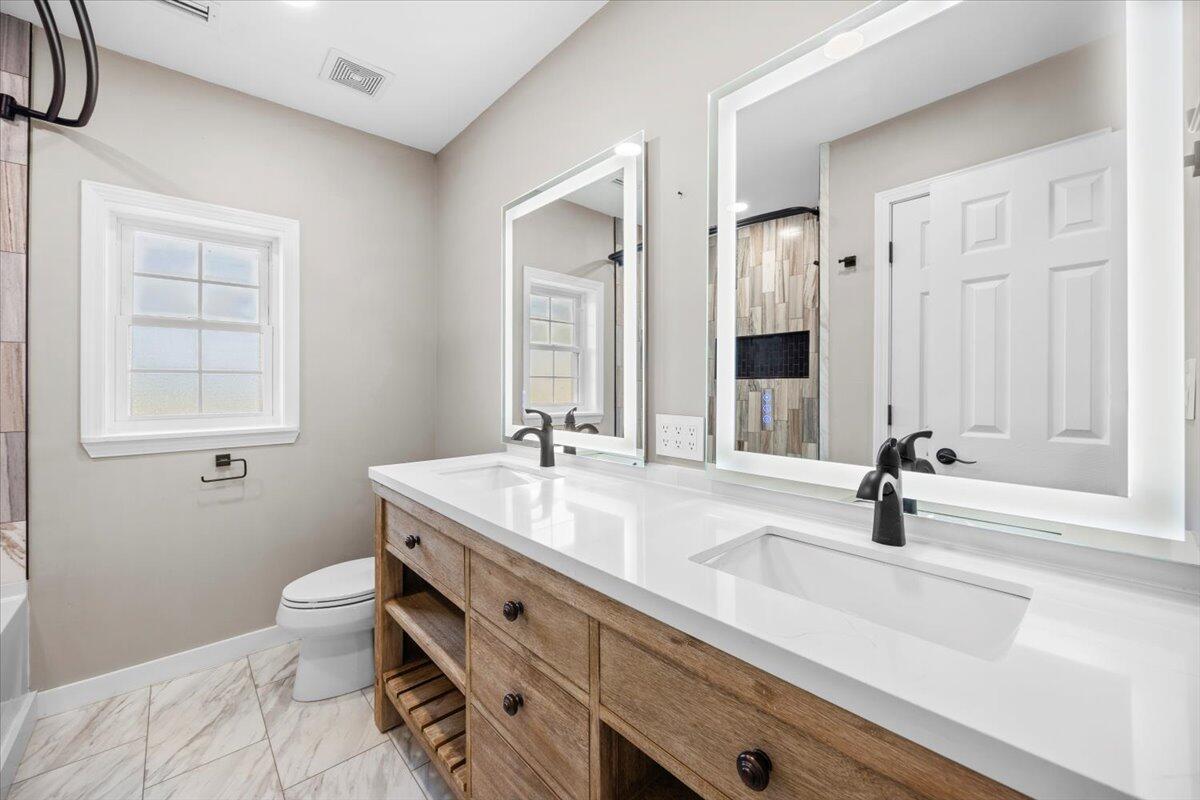 1512 Vinson Ray Road Baker, FL 32531 - Photo 54 of 71 a bathroom with a sink double vanity and a mirror