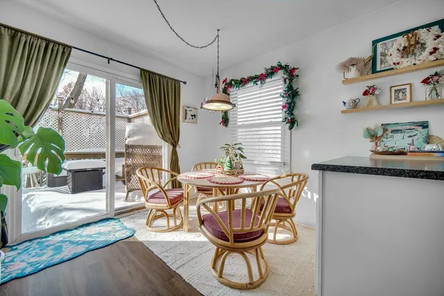 a dining room with furniture window and wooden floor