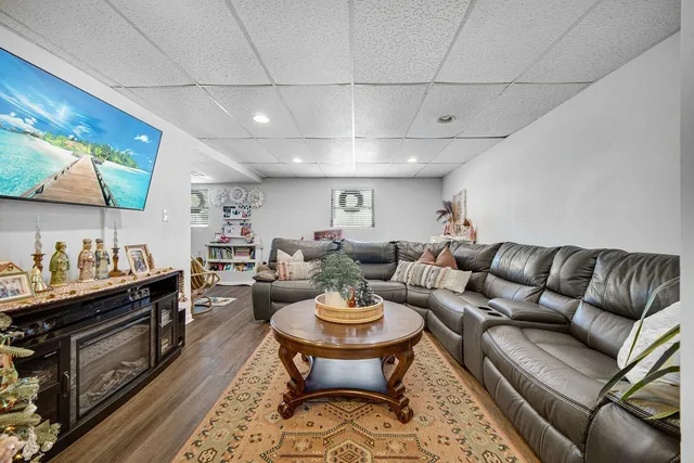a living room with furniture a rug and a dining table
