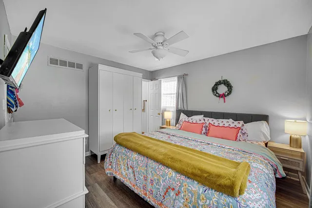 a bedroom with a bed and a chandelier