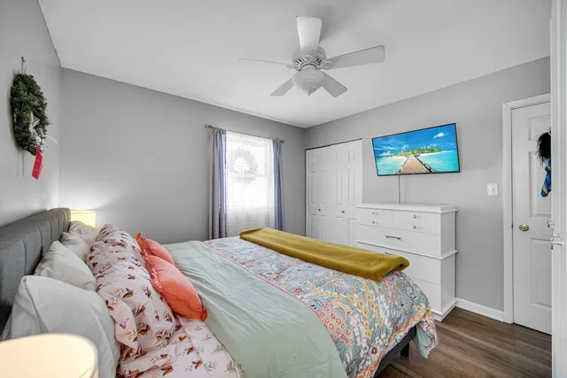 a bedroom with a bed and a painting on the wall