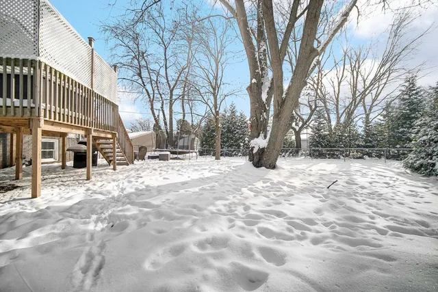 a view of snow on the roadside