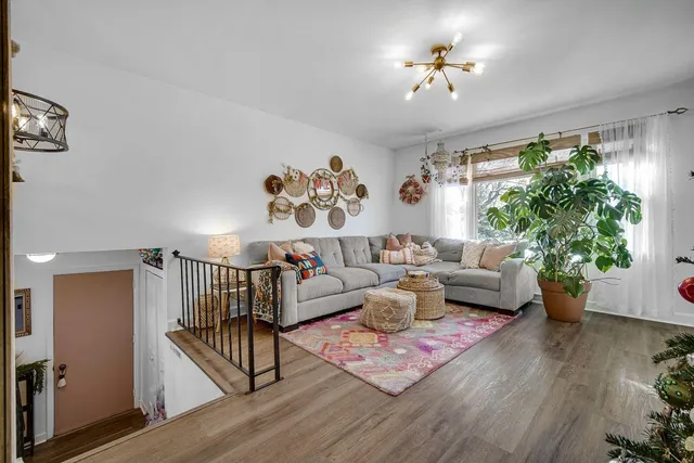 a living room with furniture and a chandelier