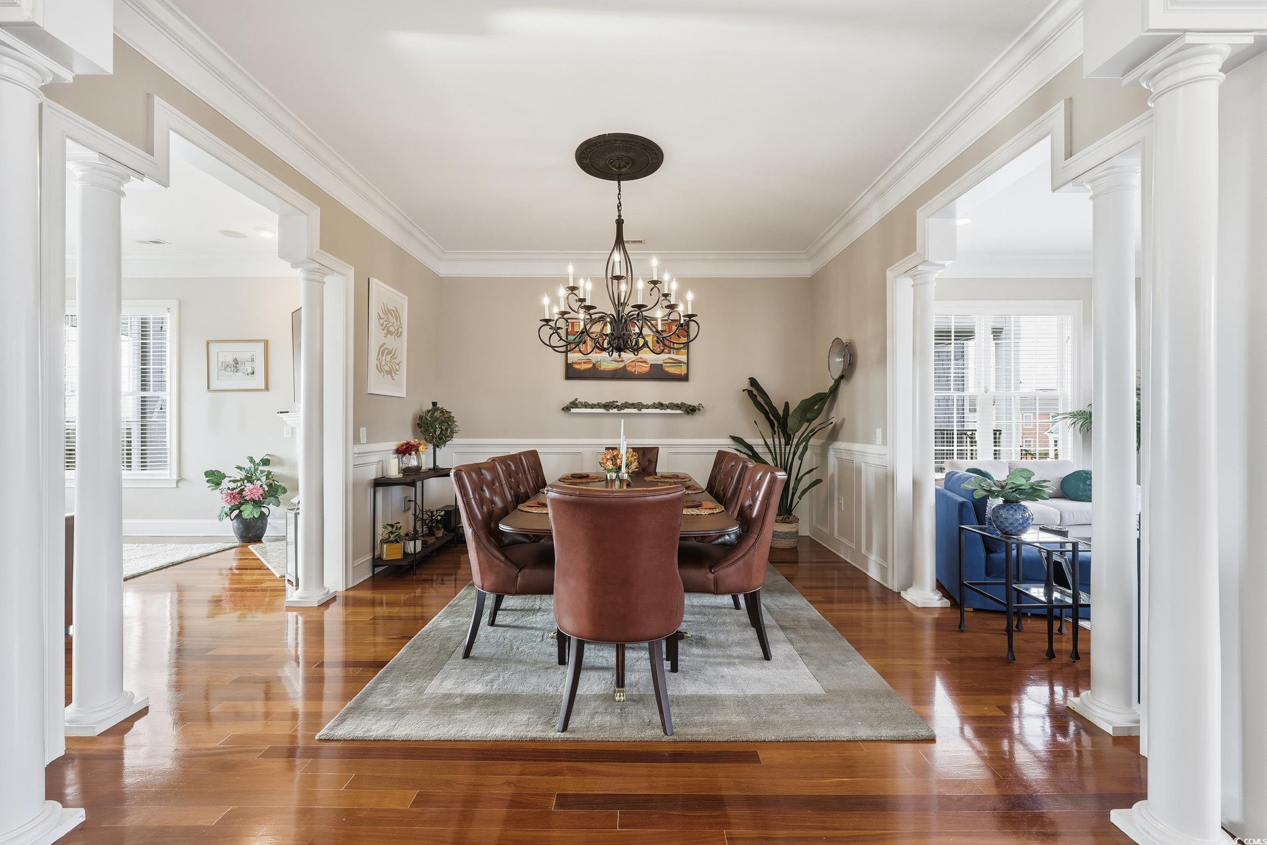 349 St.Julian Lane Myrtle Beach, SC 29579 - Photo 7 of 40 Dining room featuring decorative columns, ornamental molding, plenty of natural light, and dark wood finished floors
