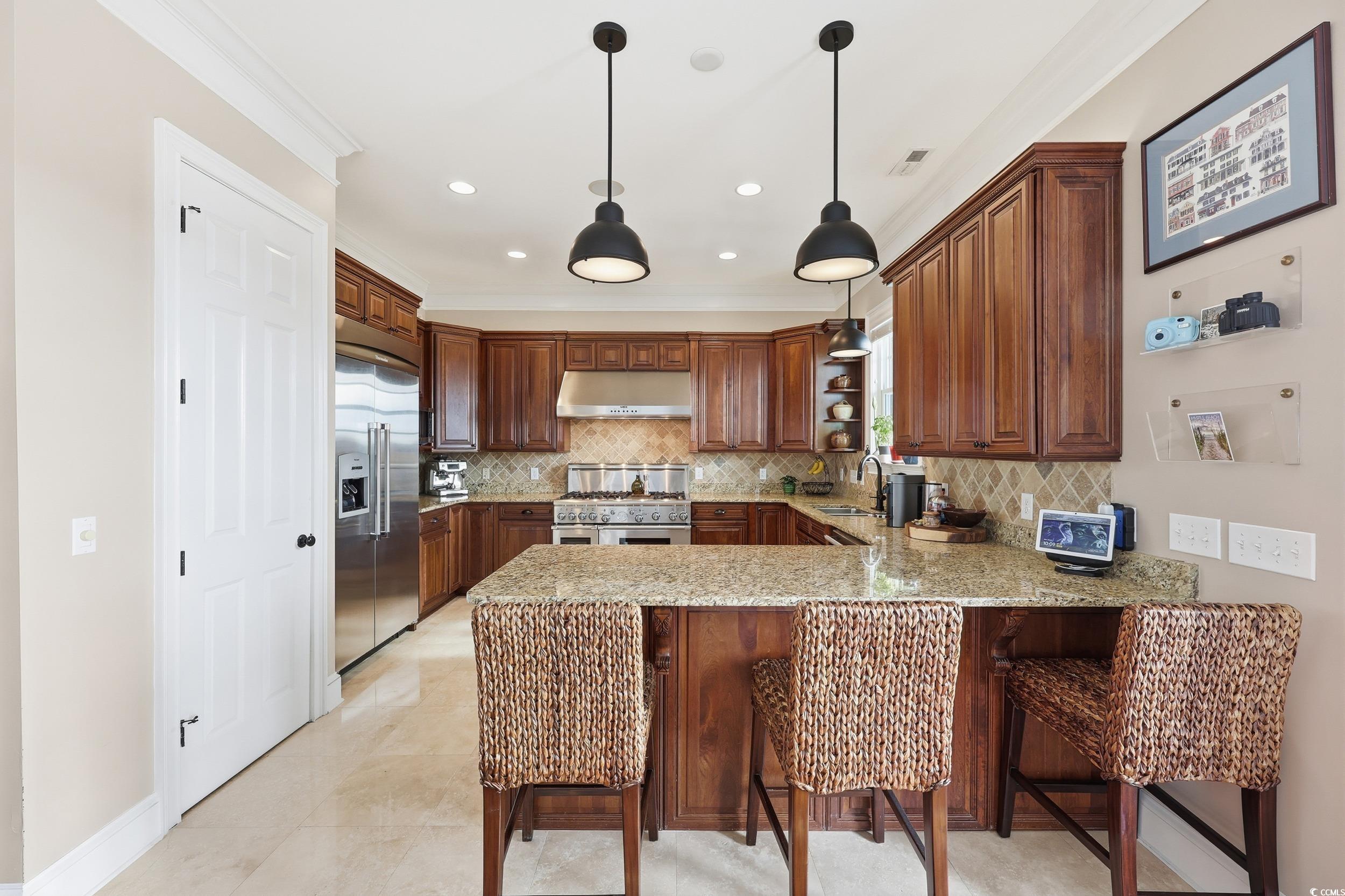349 St.Julian Lane Myrtle Beach, SC 29579 - Photo 8 of 40 Kitchen featuring a kitchen breakfast bar, light stone countertops, high end appliances, pendant lighting, and a peninsula