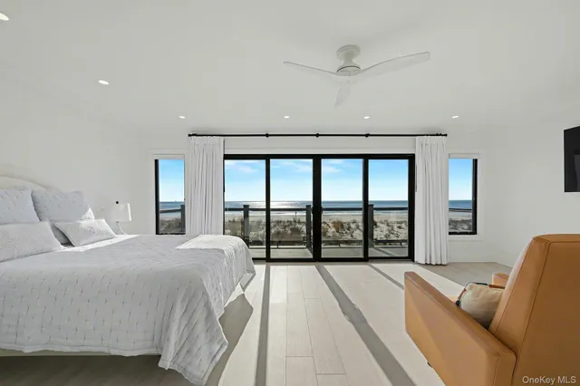 a bedroom with a large bed and a large window