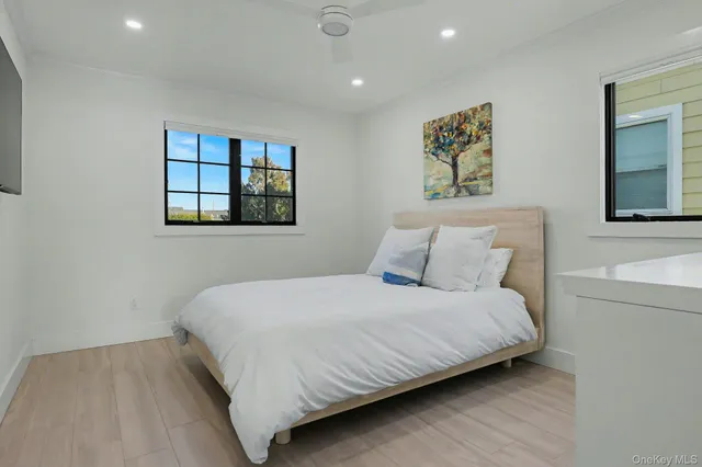 a bedroom with a bed and a night stand