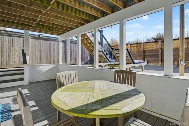 a view of a chairs and table in the balcony