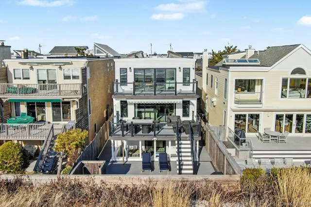 a front view of a building with a garden and plants