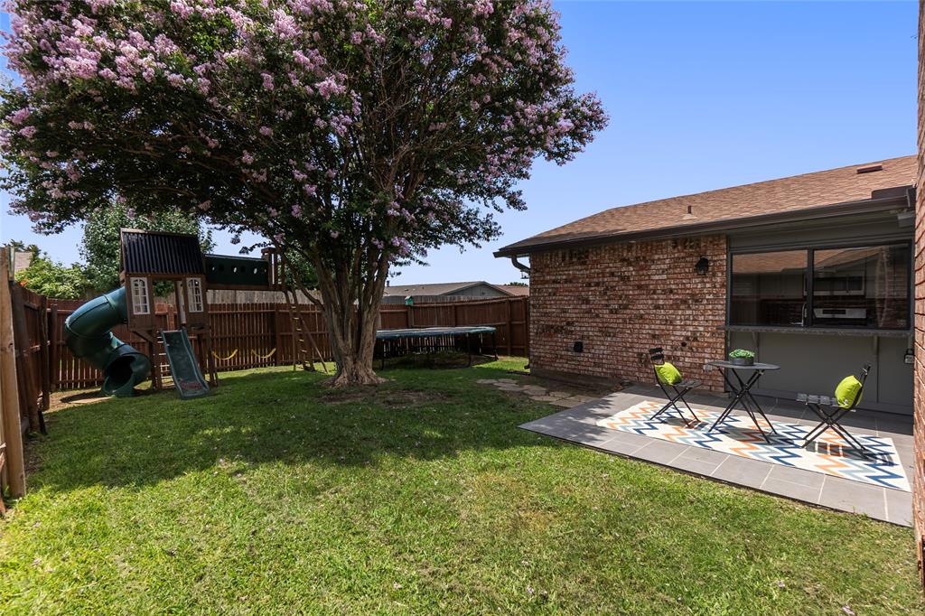 2004 White Ash Road Carrollton, TX 75007 - Photo 31 of 40 Beautiful crepe myrtle tree & grassy backyard; Playset & trampoline stay
