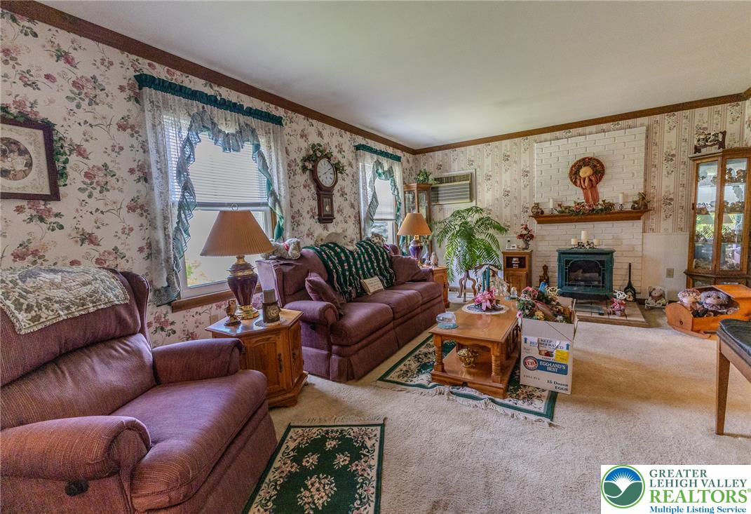 40 Locke Heights Road Bangor, PA 18013 - Photo 12 of 28 A comforting living area with a fireplace and ample space for gatherings.