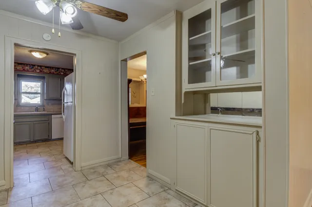 a view of an empty room with a kitchen