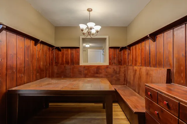 a room with pool table and chandelier