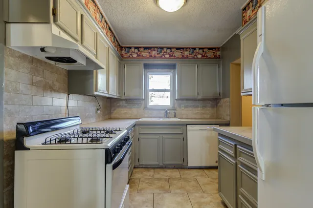 a kitchen with a stove and a refrigerator
