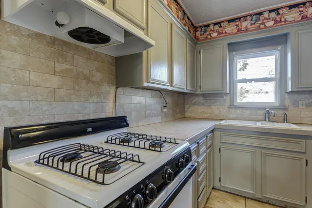 a kitchen with a stove and a sink