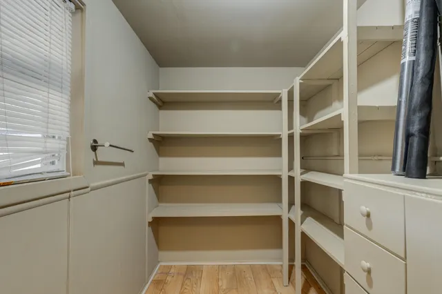 a view of walk in closet with empty racks