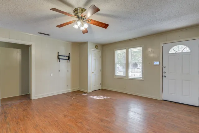 wooden floor in an empty room with a window